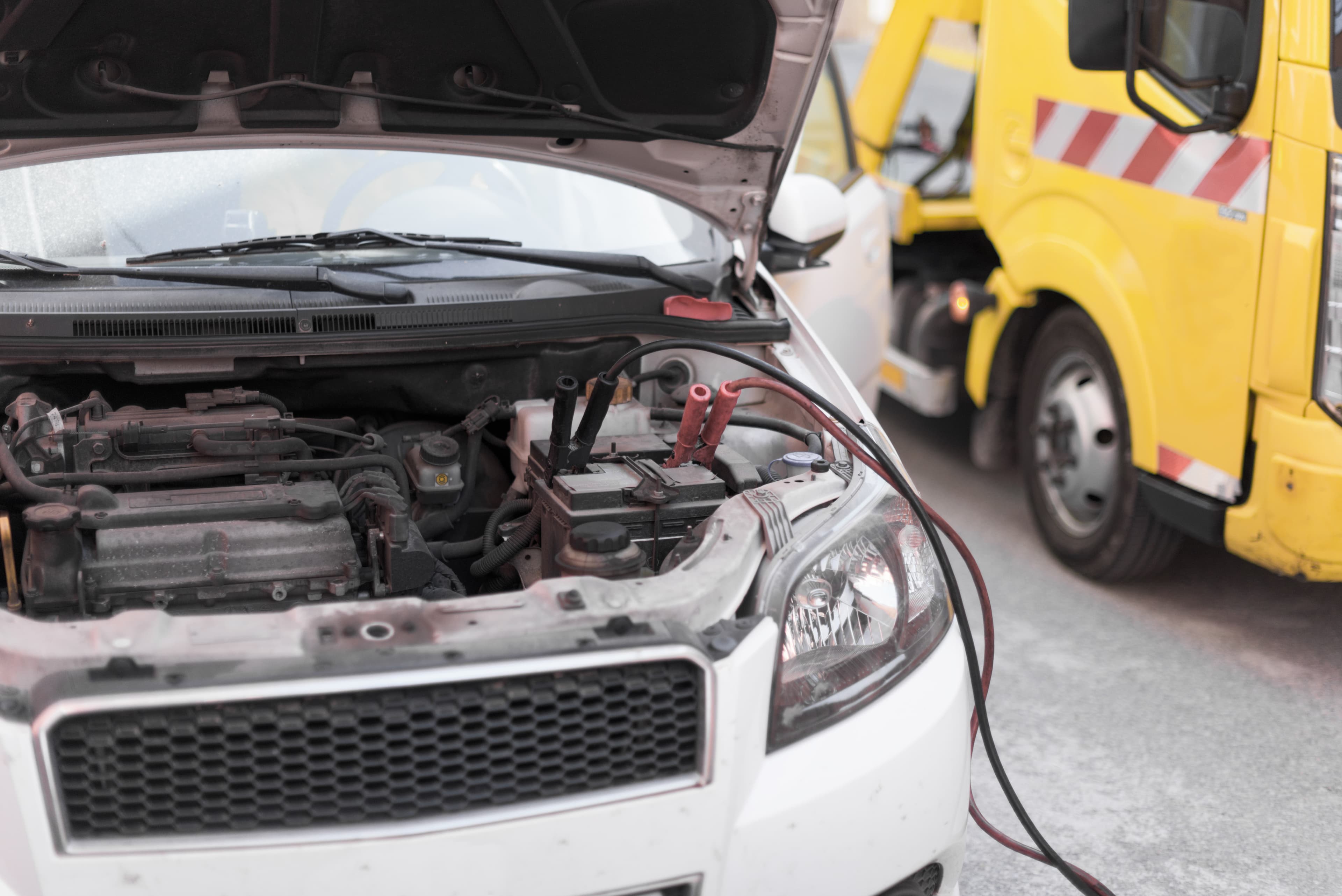 Tow truck assisting a stranded vehicle during a roadside call.